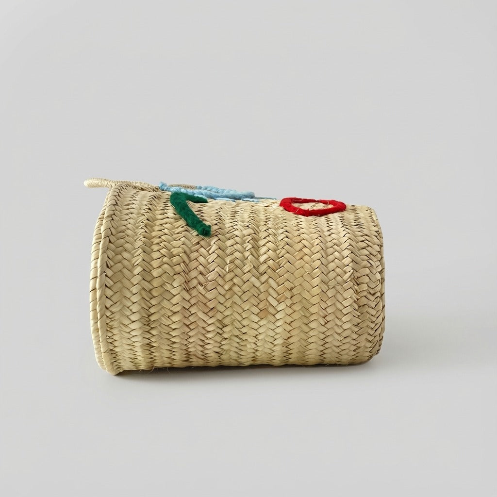Woven Straw Market Tote Bag with Embroidered Winking Face Design