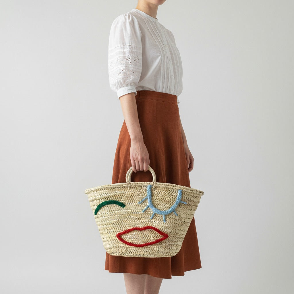 Woven Straw Market Tote Bag with Embroidered Winking Face Design
