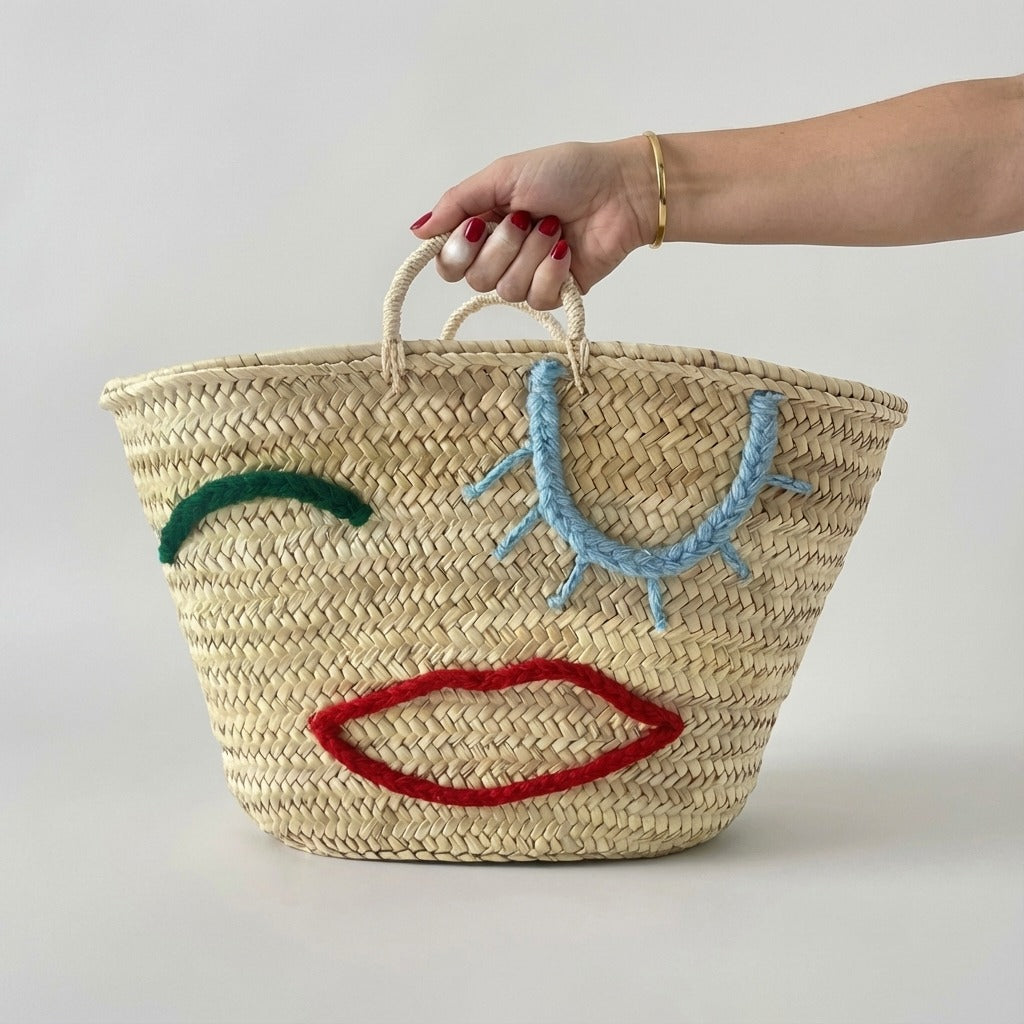 Woven Straw Market Tote Bag with Embroidered Winking Face Design